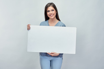 Smiling woman holding white advertising board with empty copy sp
