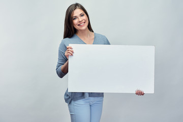 Smiling woman holding white advertising board with empty copy sp