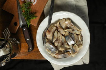  tasty herring. seafood on a plate (a herring fish in marinade) - cuisine.  Food background