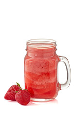 Strawberry smoothie in jar and two whole berries on white