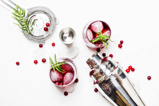 Cranberry Cocktail With Ice, Rosemary And Berries, Bar Tools, White Background, Top View