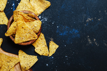 Salted Mexican Corn Nachos iIn Wooden Bowl, Black Background, Top View © 5ph