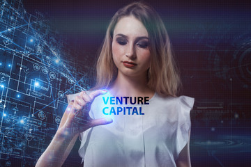 The concept of business, technology, the Internet and the network. A young entrepreneur working on a virtual screen of the future and sees the inscription: Venture capital