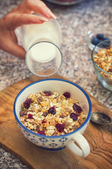 Young women eating healthy breakfast,granola with fresh berry fruits