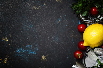 Bloody mary alcoholic cocktail with red tomato, lemon juice, hot sauce, green celery and russian vodka, black stone background, top view