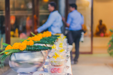 To make merit by offering food to monk ceremony in Thai wedding tradition.Selective focus on Flower bouquet.