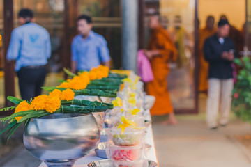 To make merit by offering food to monk ceremony in Thai wedding tradition.Selective focus on Flower bouquet.