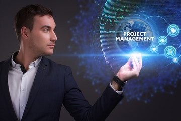 Business, Technology, Internet and network concept. Young businessman working on a virtual screen of the future and sees the inscription: Project management