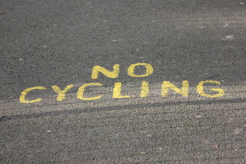 yellow no cycling sign on road, London, England