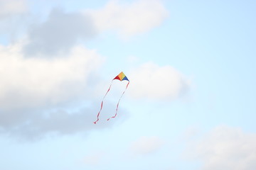 colored kite on a cloudy sky