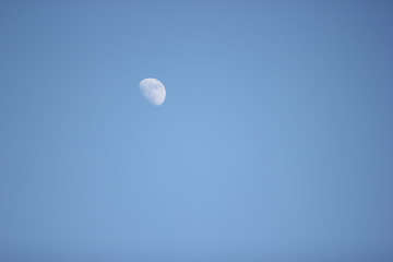 a picture of the moon on a clear blue sky