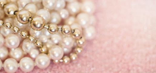 White and golden pearls necklace on pink background - birthday gift idea for women