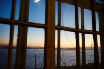 View of beautiful sunset over river from window of workshop. 