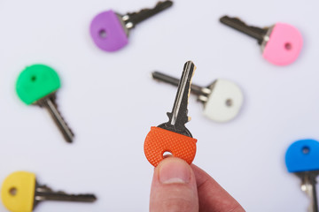 Hand holding one colorful key