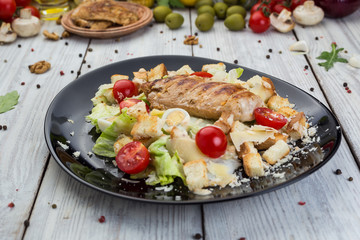 Healthy Grilled Chicken Caesar Salad with Cheese, Croutons and Cherry Tomatoes