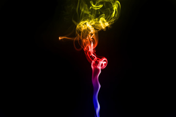 abstract fragment movement of colorful red blue and yellow gradient smoke on black background.