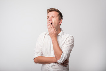 Portrait of caucasian yawning man.