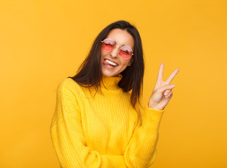 Stylish hipster girl showing two fingers