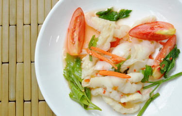 spicy chicken foot with chili and lime salad on white plate