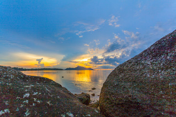 scenery sunrise above big rocks in Rawai sea