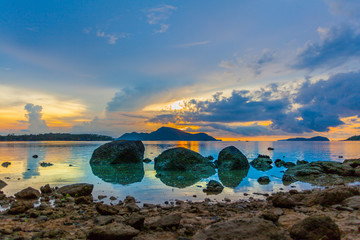 scenery sunrise above big rocks in Rawai sea