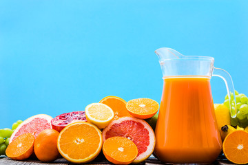 Healthy juice with fruits, tropical juice with orange, grapefruit, lemon, mandarin, refreshing fruit drink for summer
