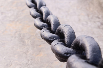 Black thick steel chain. Chain for fencing. Close-up. Background.