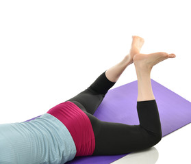 Mother woman exercising doing postnatal workout. Female fitness stretching hands and legs in gym work out exercises