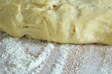 Dough and flour on the board. Close-up.