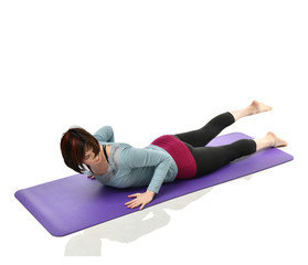 Mother woman exercising doing postnatal workout. Female fitness stretching hands and legs in gym...