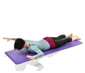 Mother woman exercising doing postnatal workout. Female fitness stretching hands and legs in gym...