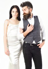 Woman in wedding dress and man in vest. Wedding concept. Couple in love, bride and groom in elegant wedding clothes, white background. Bearded hipster with bride dressed up for wedding ceremony.