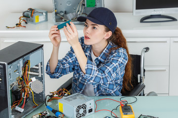 young woman technician repairing a computer