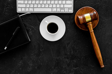 Work desk of contemporary lawyer. Lawyer office concept. Judge gavel near computer keyboard, respectable notebook on black background top view copy space