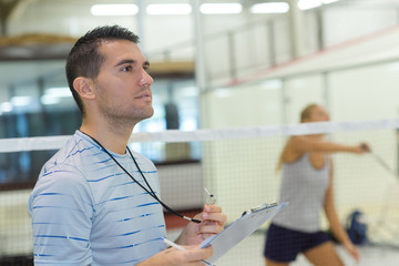 teacher giving badminton lesson