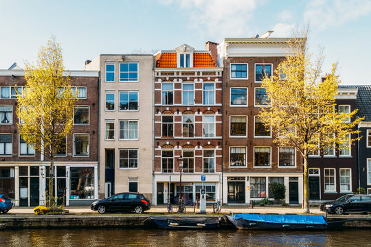 Beautiful Architecture Of Dutch Houses and Houseboats On Amsterdam Canal In Autumn