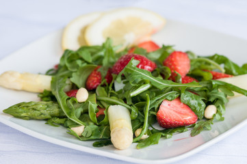 Delicious  fresh vegetarian salad with asparagus, strawberries  and arugula

