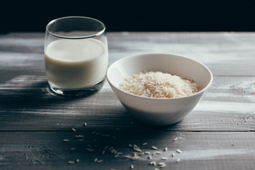 Rice milk and rice seeds on wooden table background