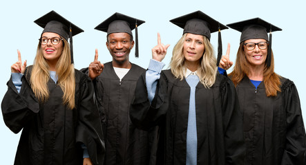 Education concept, university graduate woman and man group happy and surprised cheering expressing wow gesture pointing up