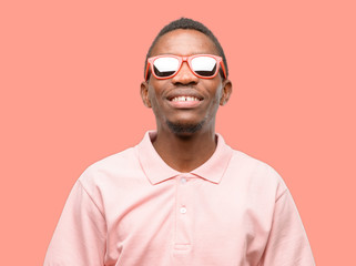 African black man wearing sunglasses thinking and looking up expressing doubt and wonder