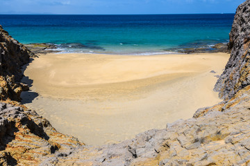 Fototapeta na wymiar Secluded beach in the Papagayo Coast in Lanzarote, Spain