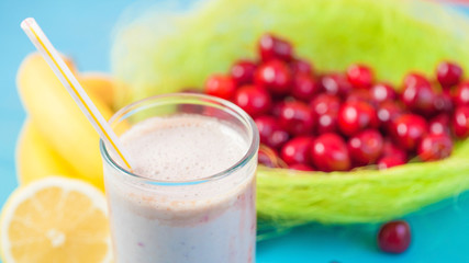 a glass of milk smoothies with a cherry, banana and lemon on a bright background Concept of a healthy lifestyle. Place for text. Tasty and healthy weight loss Close-up