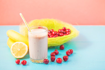 a glass of milk smoothies with a cherry, banana and lemon on a bright background Concept of a healthy lifestyle. Place for text. Tasty and healthy weight loss