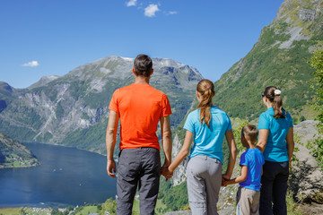 Obraz na płótnie Canvas Family with children above Geiranger Fjord.