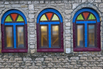 Windows in a stone building with coloured glass