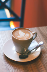 Top view of hot coffee cappuccino latte art in white ceramic cup on marble table. Coffee cup top view on old wooden. Coffee cup in coffee shop