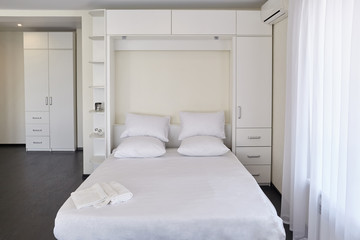 Interior of a modern studio apartment with light windows.