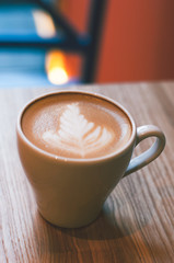 Top view of hot coffee cappuccino latte art in white ceramic cup on marble table. Coffee cup top view on old wooden. Coffee cup in coffee shop
