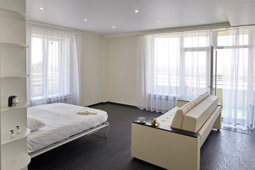 Interior of a modern studio apartment with light windows.