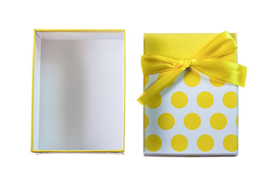 Opened yellow present box with ribbon isolated on white